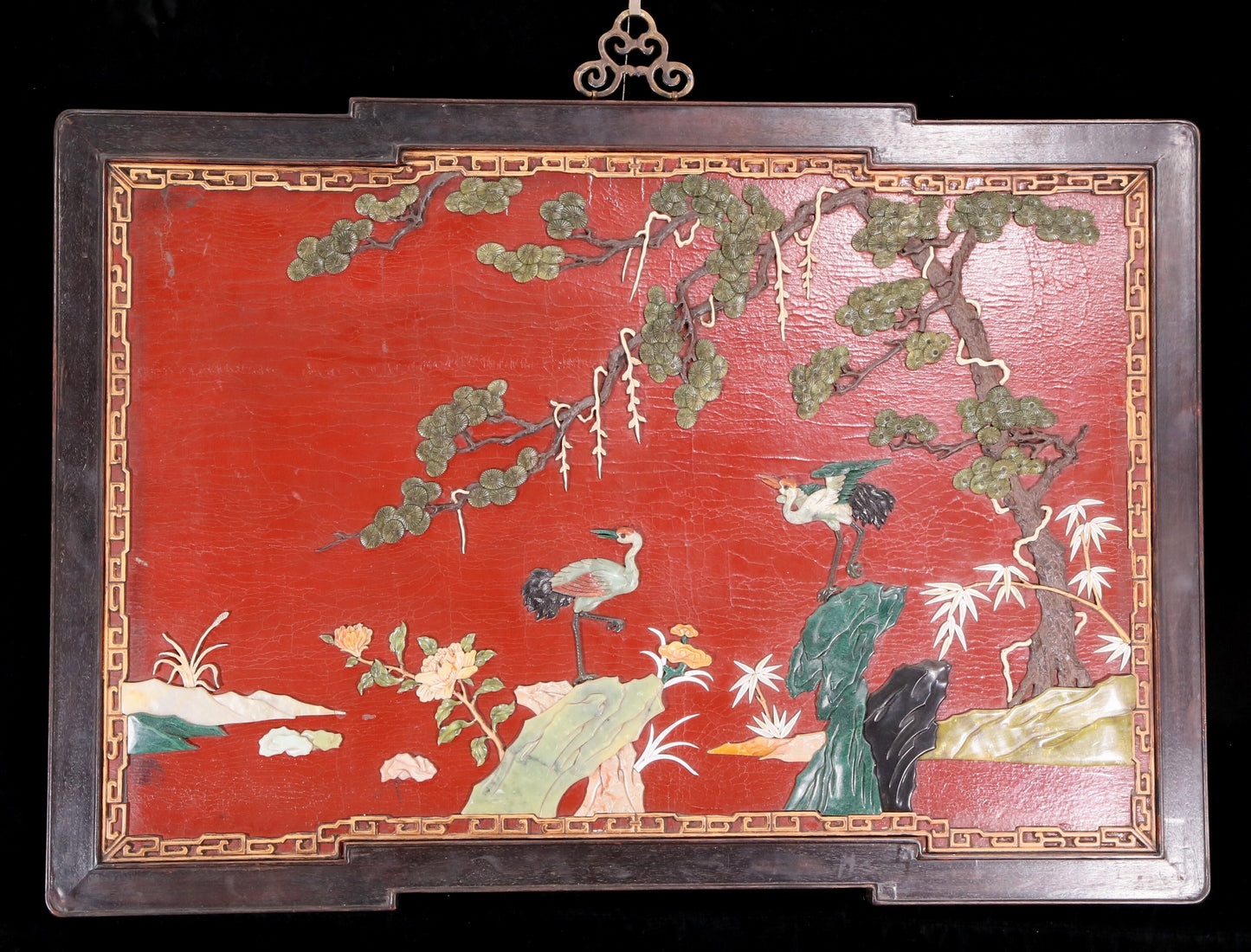 An exquisite zitanwood painted lacquered hanging screen with a pine and crane pattern inlaid with gemstones