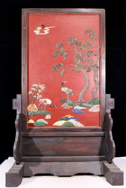 An exquisite zitanwood lacquered table screen with a pine and crane pattern inlaid with gemstones