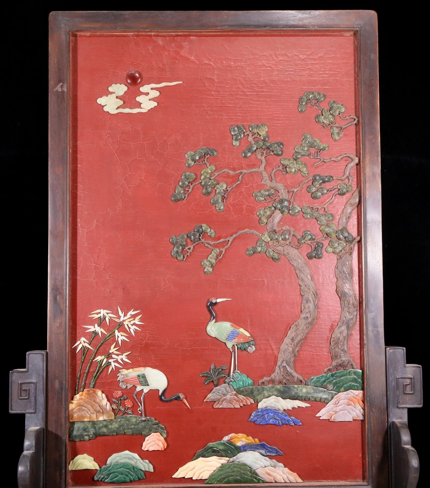 An exquisite zitanwood lacquered table screen with a pine and crane pattern inlaid with gemstones