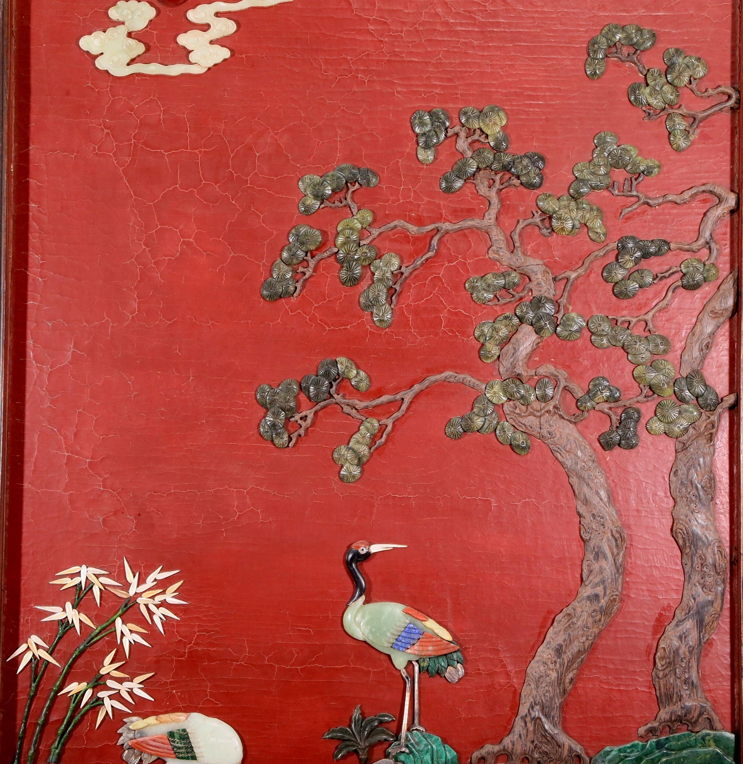 An exquisite zitanwood lacquered table screen with a pine and crane pattern inlaid with gemstones