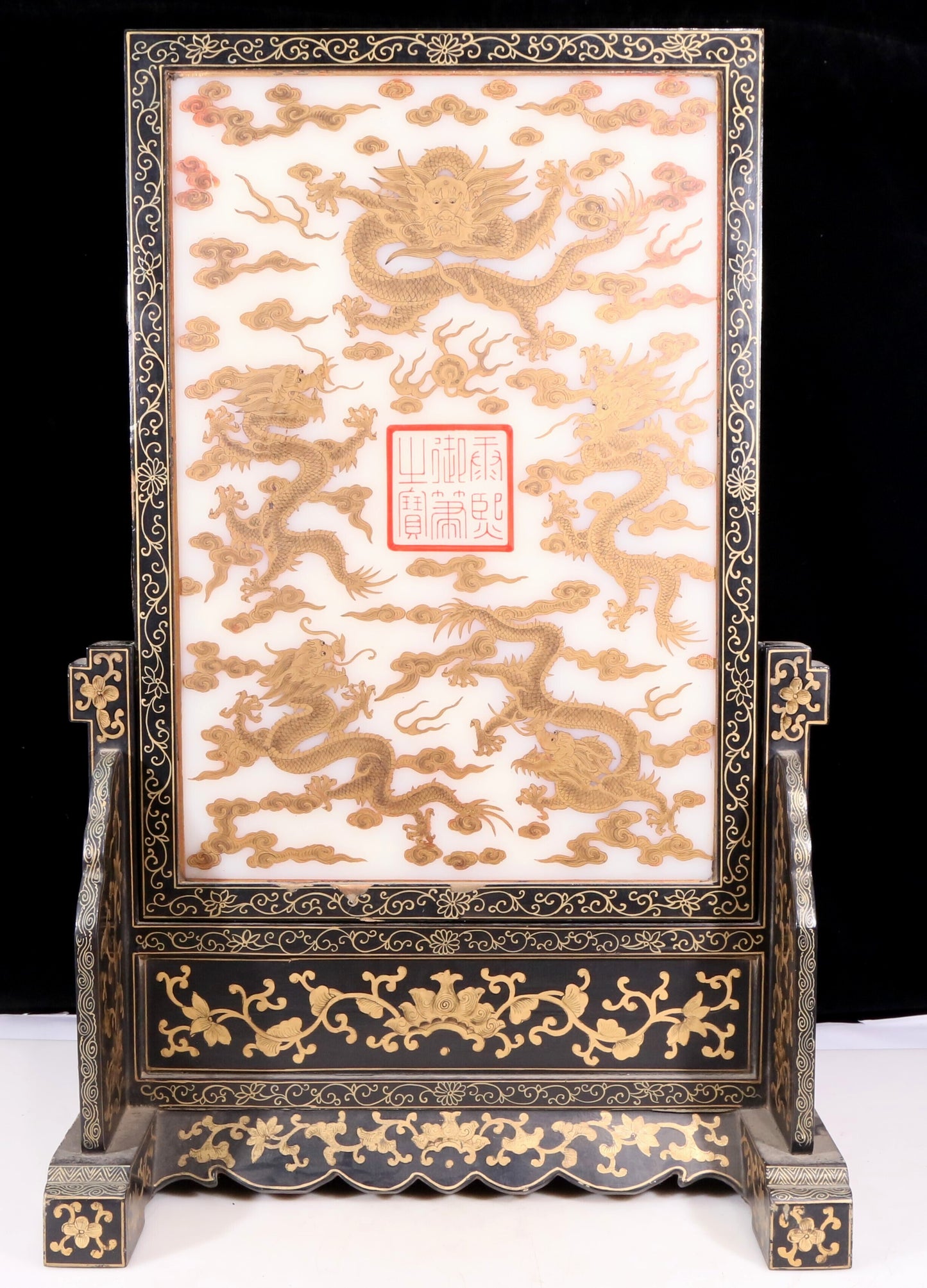 An exquisite zitanwood lacquered table screen with gold floral and dragon patterns