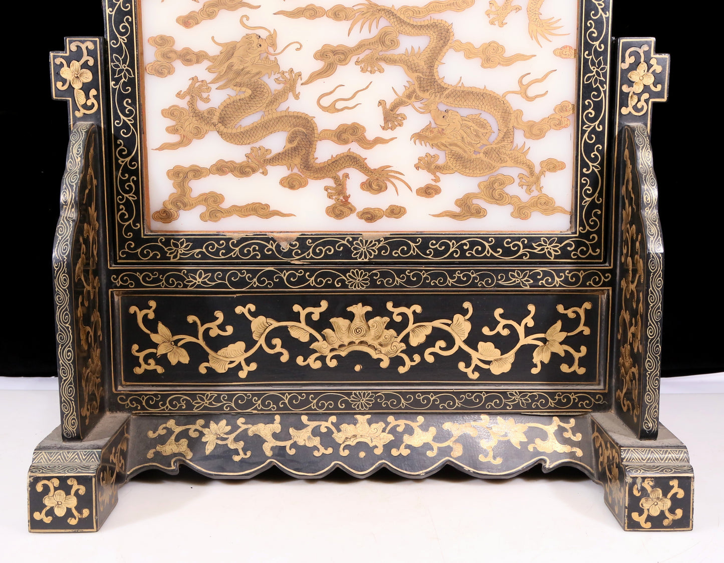 An exquisite zitanwood lacquered table screen with gold floral and dragon patterns