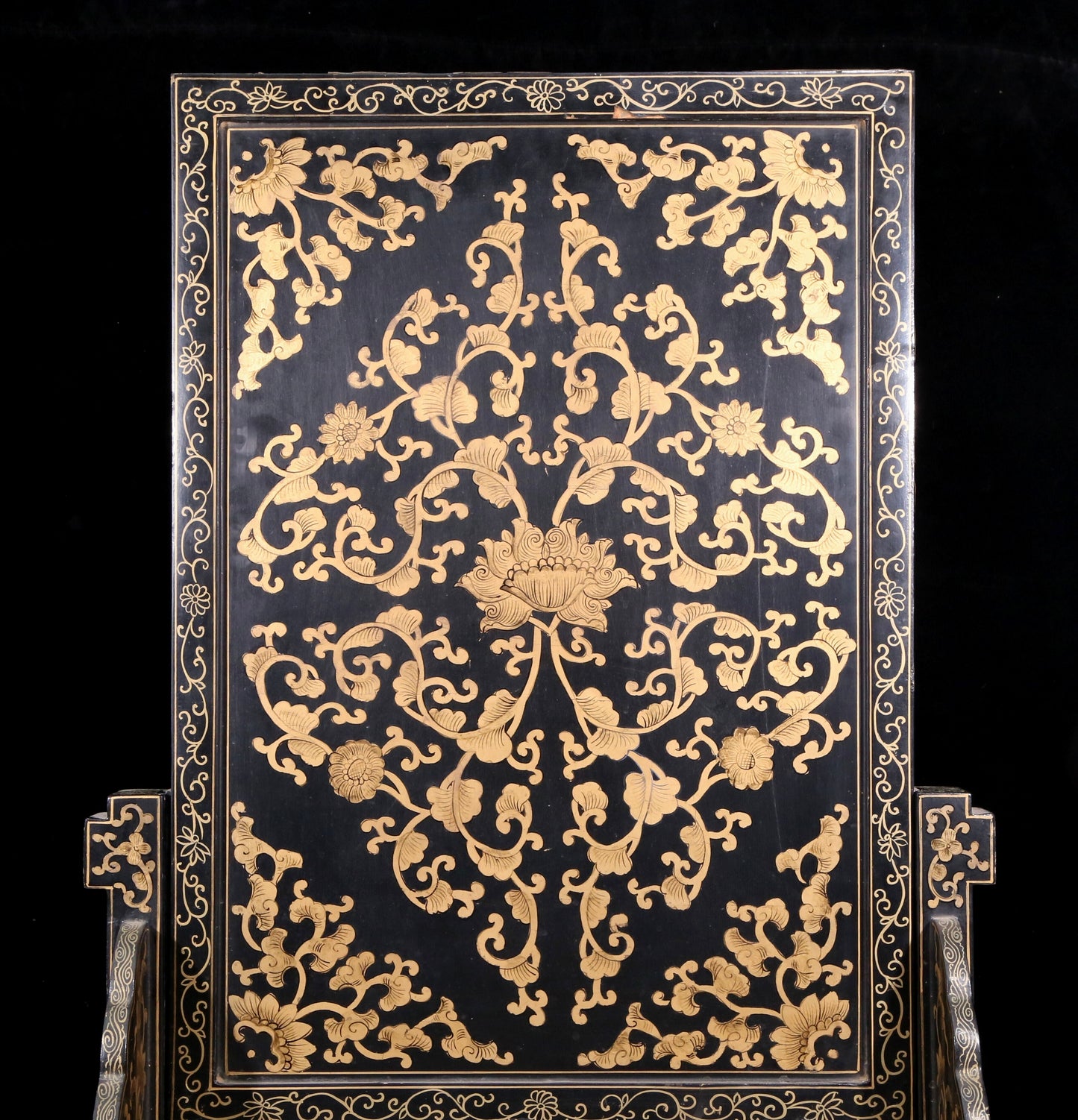 An exquisite zitanwood lacquered table screen with gold floral and dragon patterns