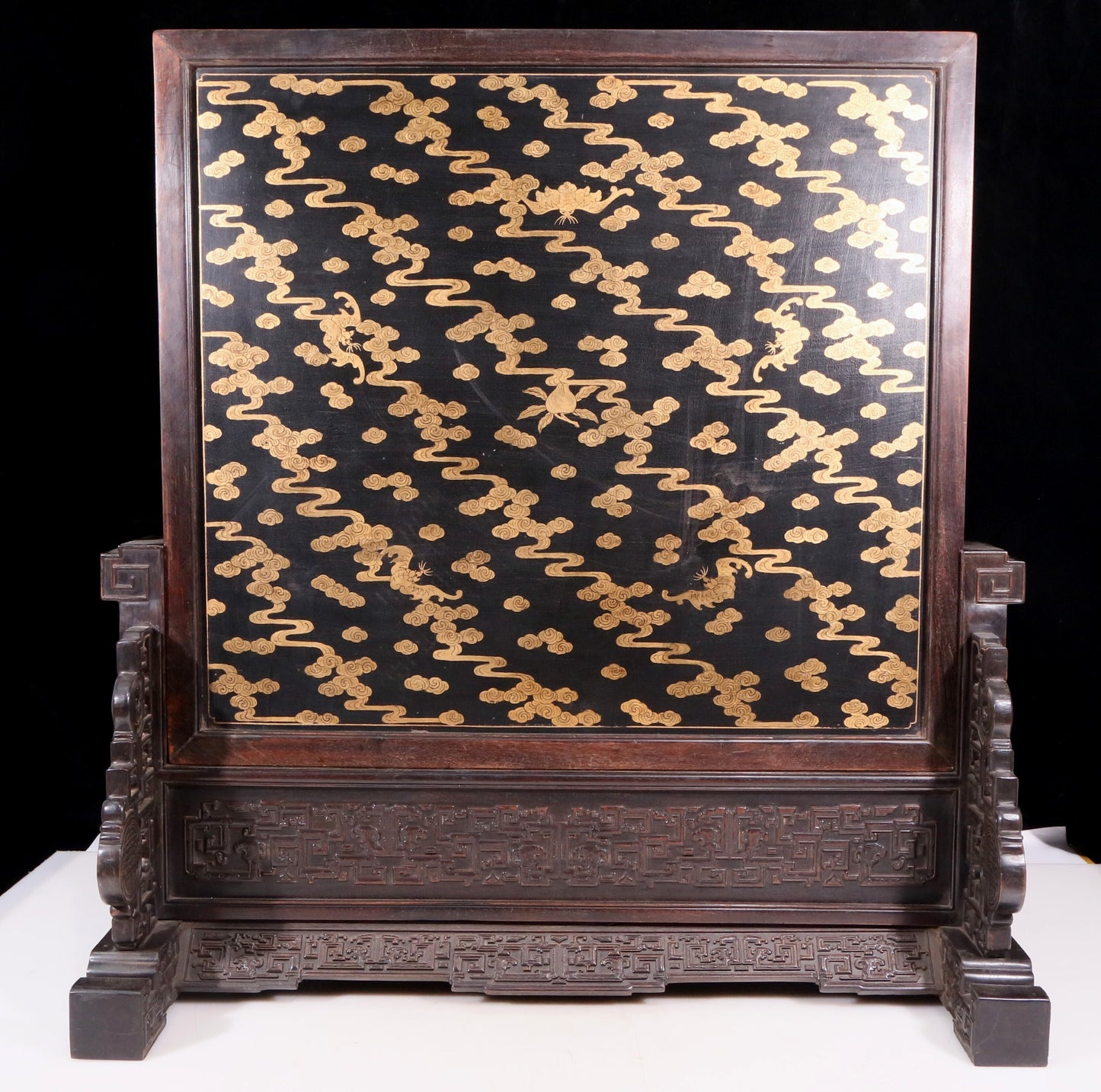 An exquisite zitanwood table screen filled with lacquer, painted with gold and inlaid with white jade with landscape and figure patterns.