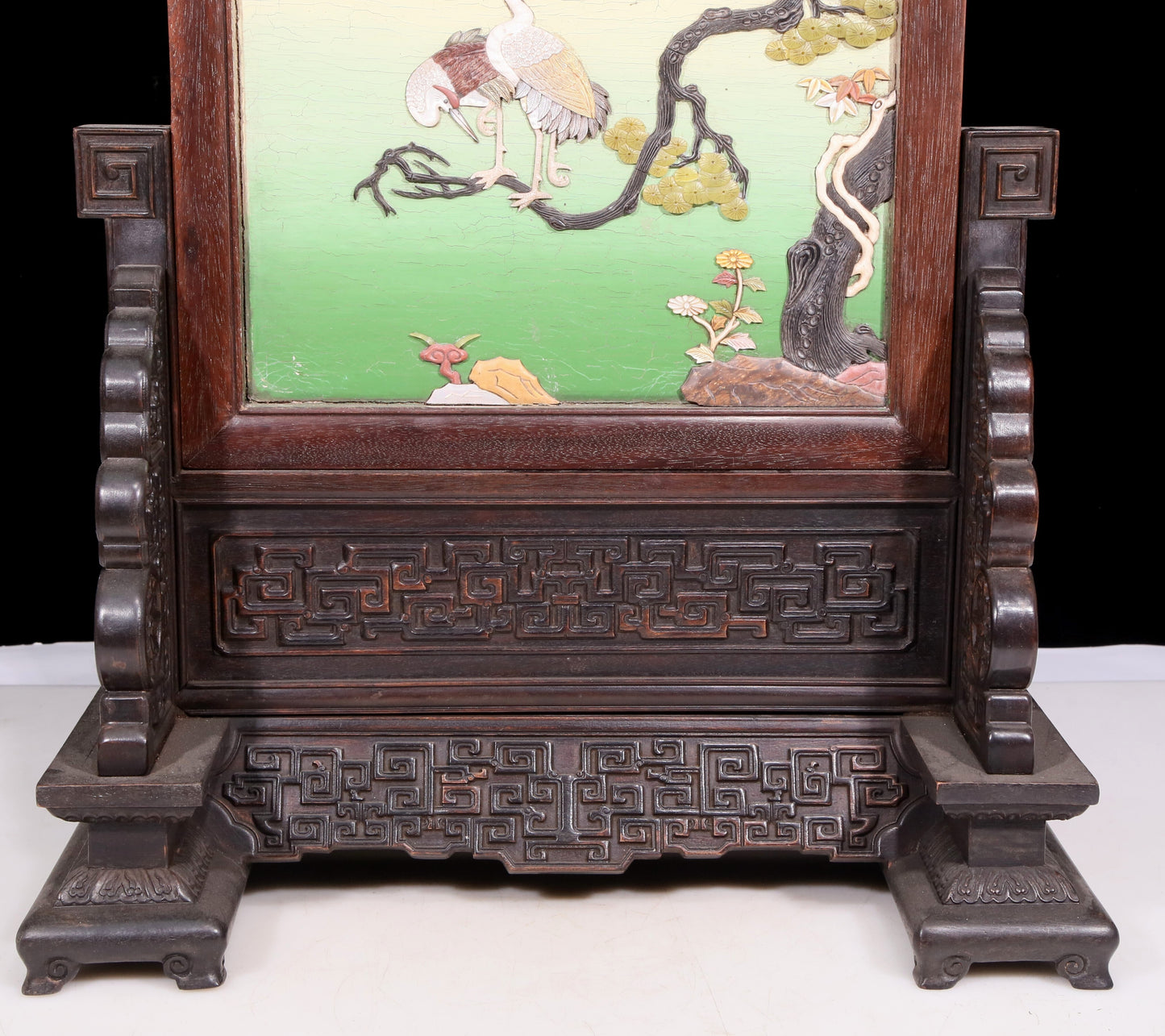 An exquisite zitanwood lacquered and gold-embedded pine and crane pattern table screen