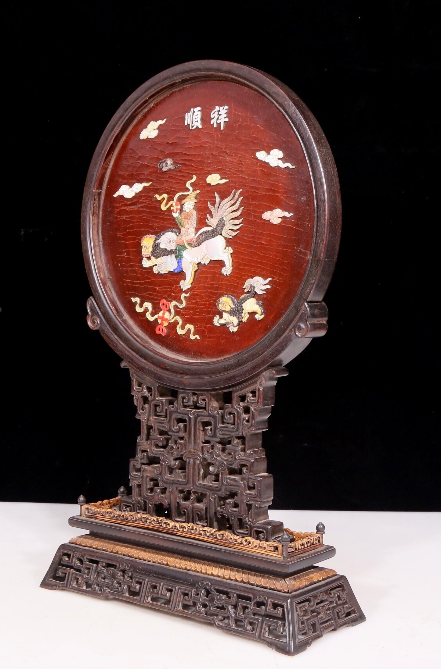 An exquisite zitanwood lacquered and gold-embedded table screen with a lion opera pattern.