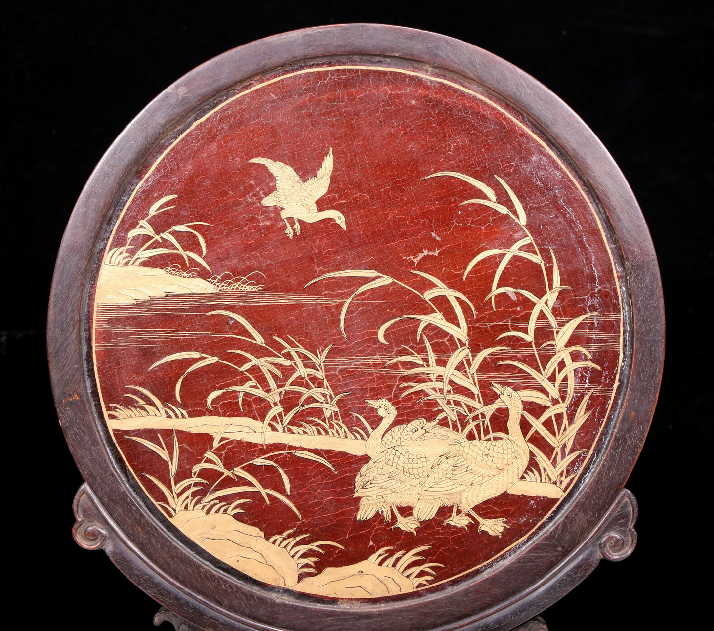 An exquisite zitanwood lacquered and gold-embedded table screen with a lion opera pattern.