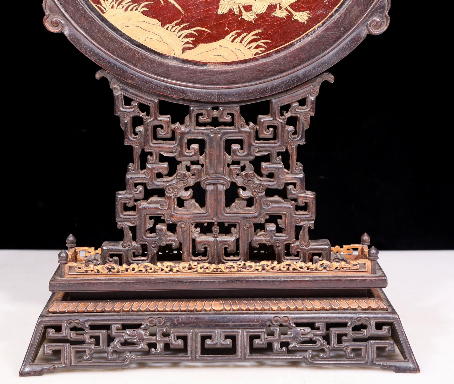 An exquisite zitanwood lacquered and gold-embedded table screen with a lion opera pattern.