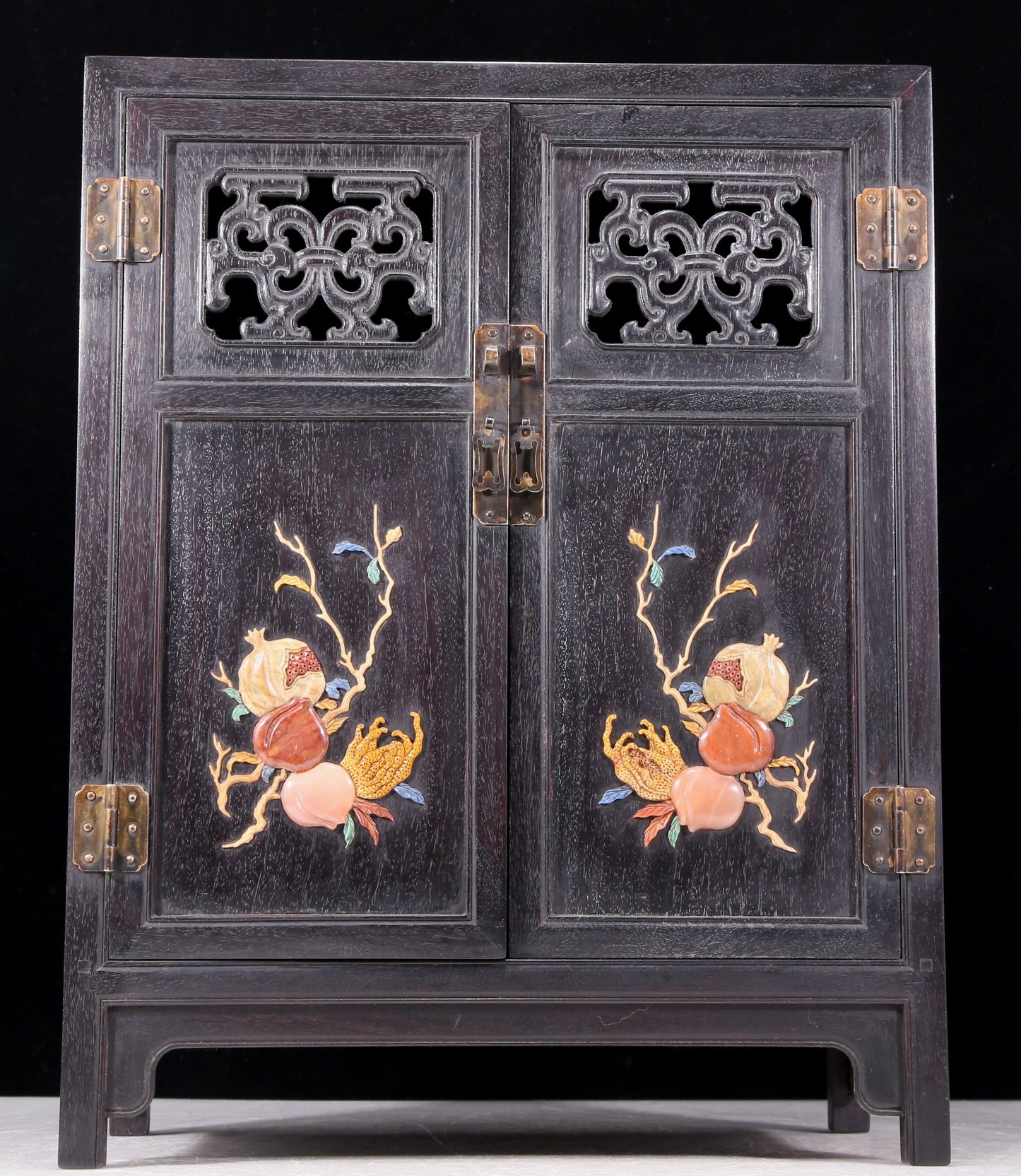 An exquisite zitanwood cabinet inlaid with gems and patterns of fortune, wealth, longevity and happiness