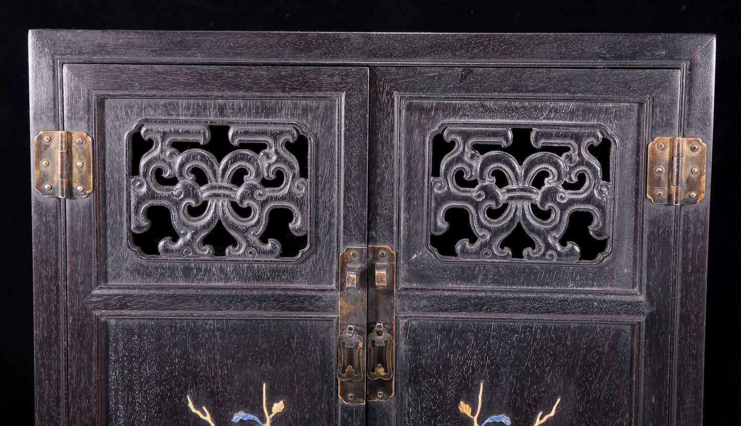 An exquisite zitanwood cabinet inlaid with gems and patterns of fortune, wealth, longevity and happiness