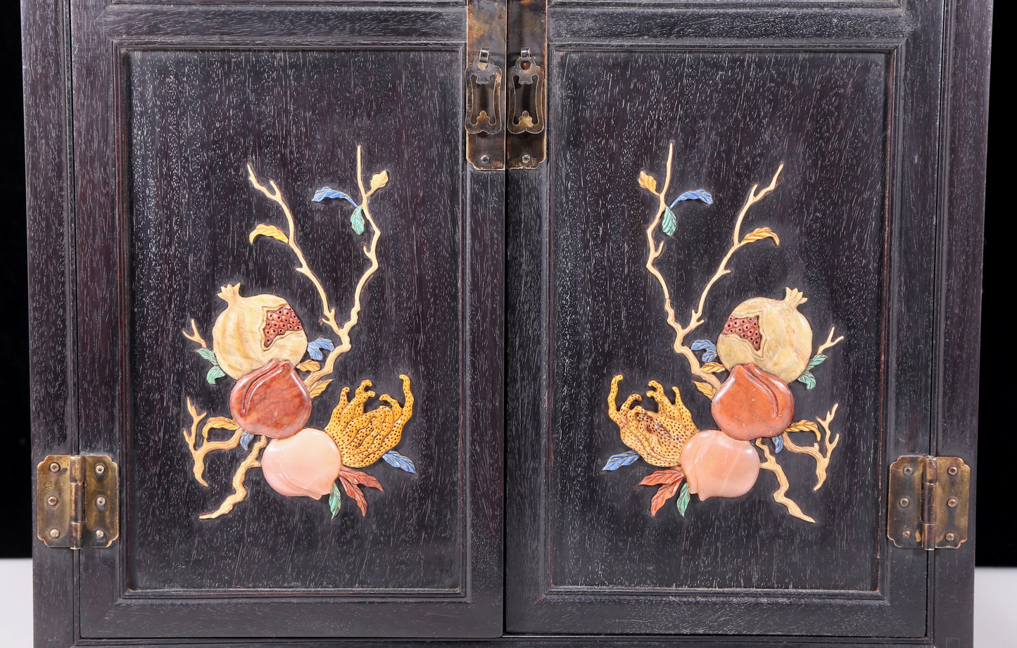 An exquisite zitanwood cabinet inlaid with gems and patterns of fortune, wealth, longevity and happiness