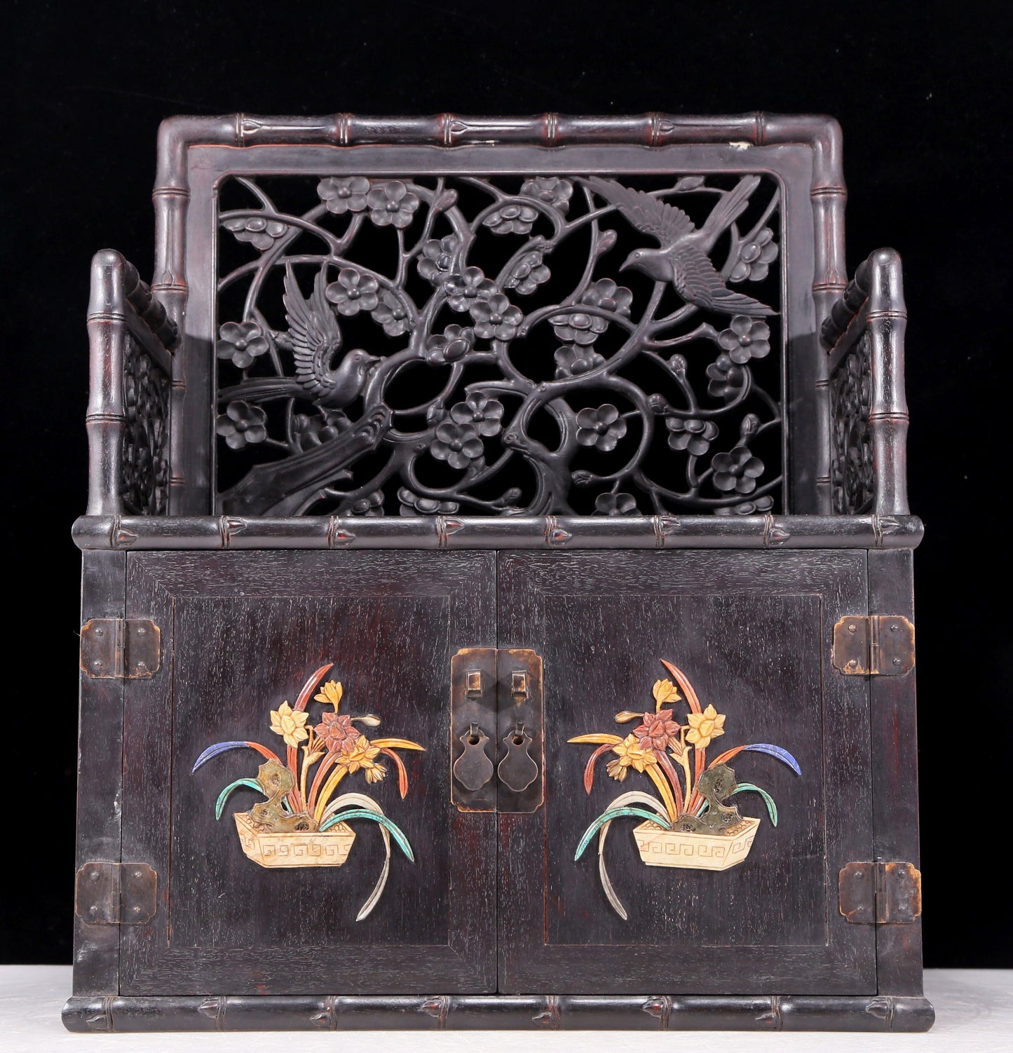 An exquisite zitanwood cabinet with inlaid gemstones and flower and bird patterns