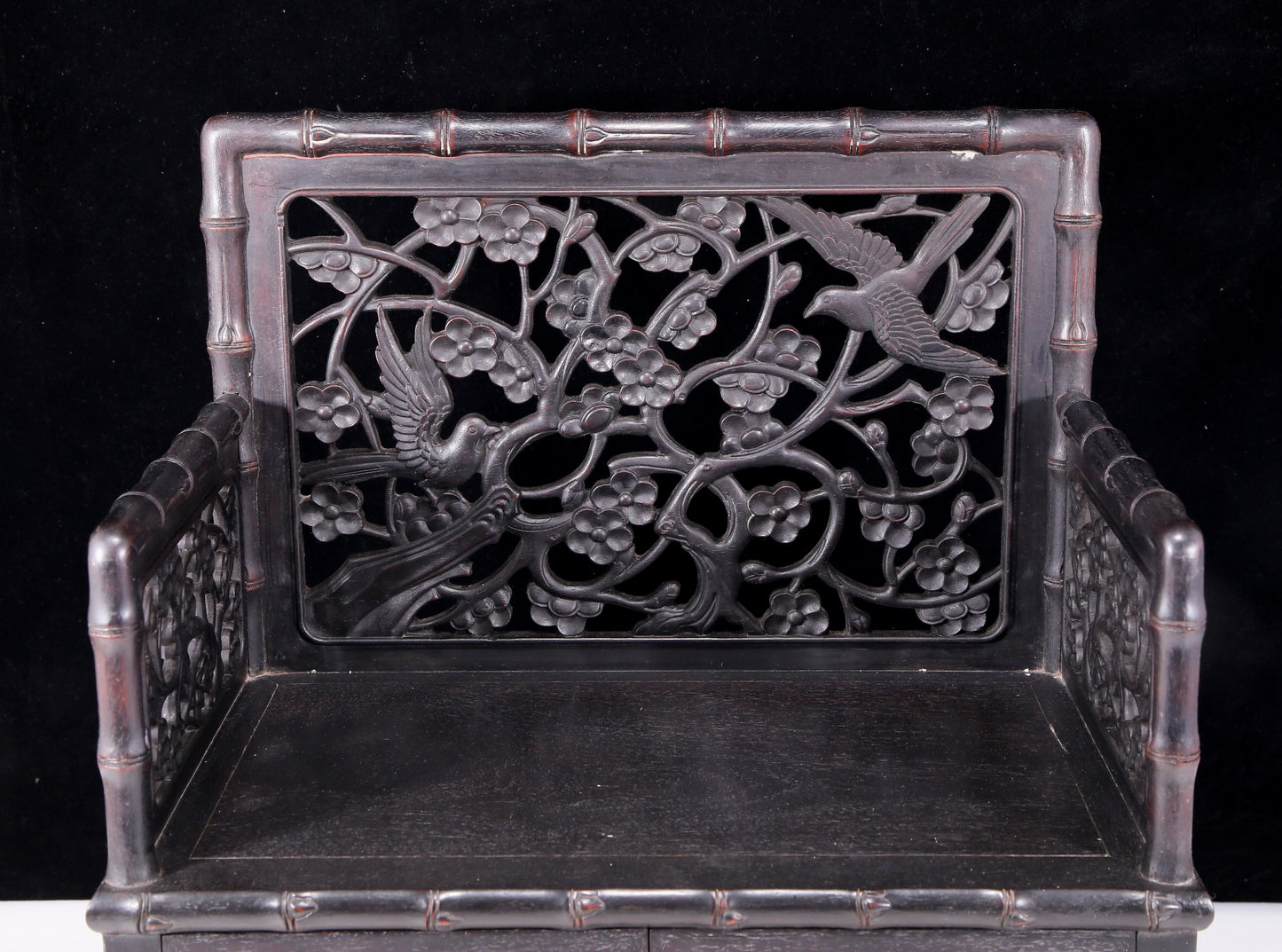 An exquisite zitanwood cabinet with inlaid gemstones and flower and bird patterns