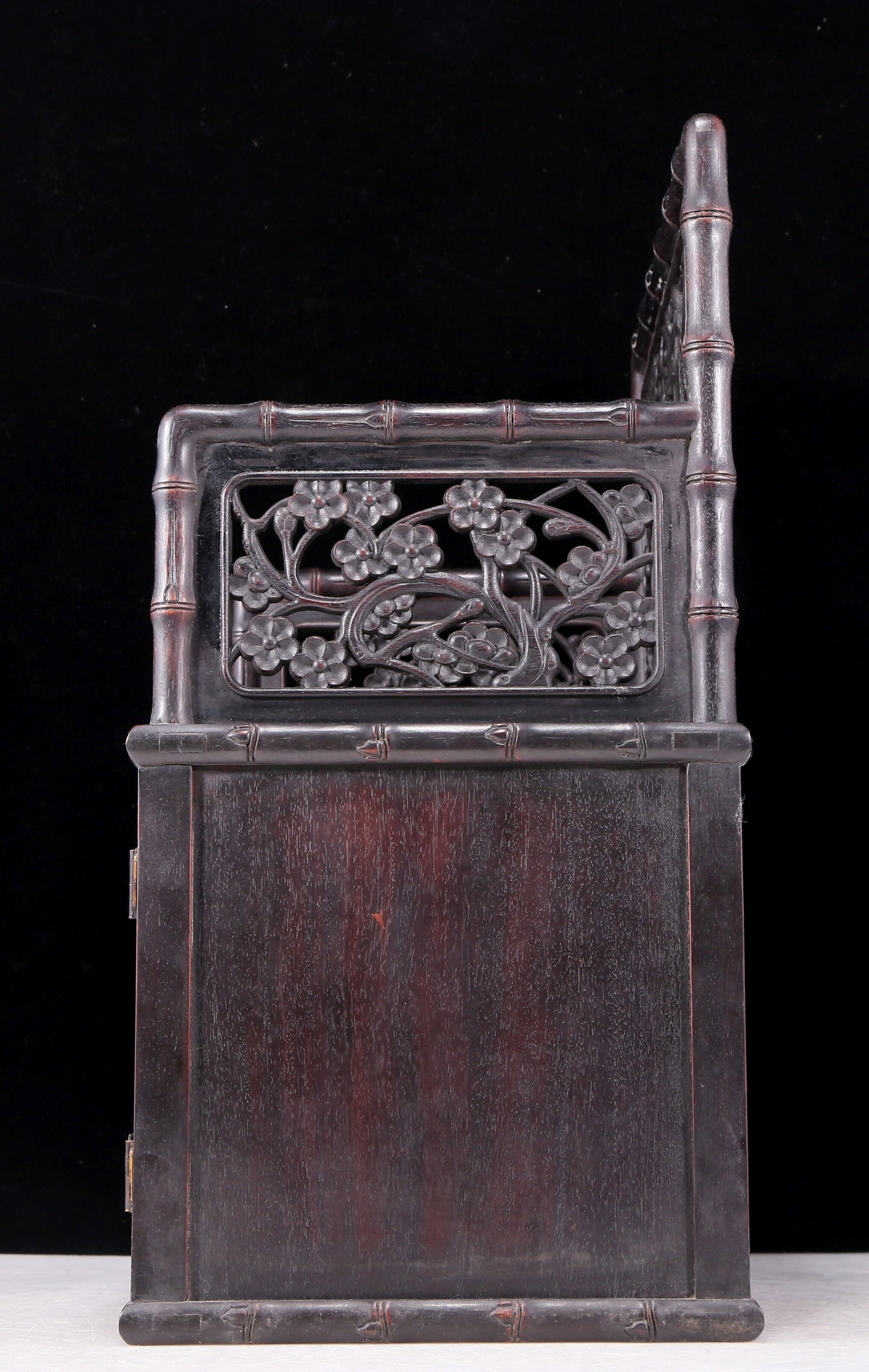 An exquisite zitanwood cabinet with inlaid gemstones and flower and bird patterns