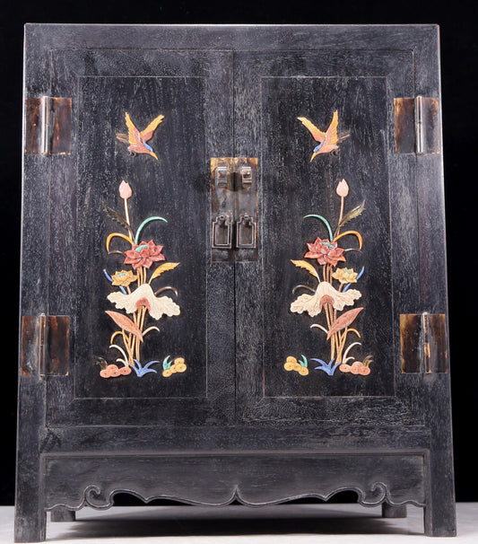 An exquisite zitanwood cabinet with inlaid gemstones and flower and bird patterns