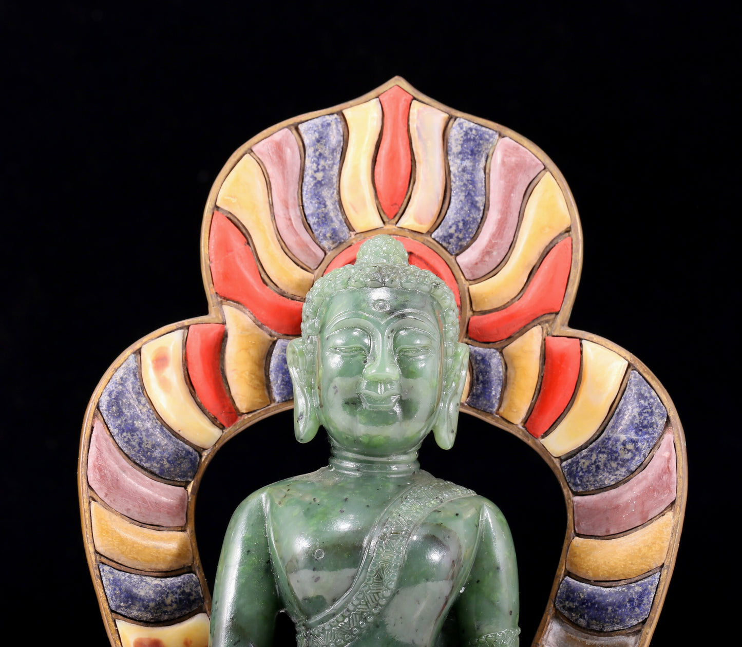 A solemn gilt bronze and gem-set jasper statue of Gautama Buddha