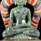 A solemn gilt bronze and gem-set jasper statue of Gautama Buddha