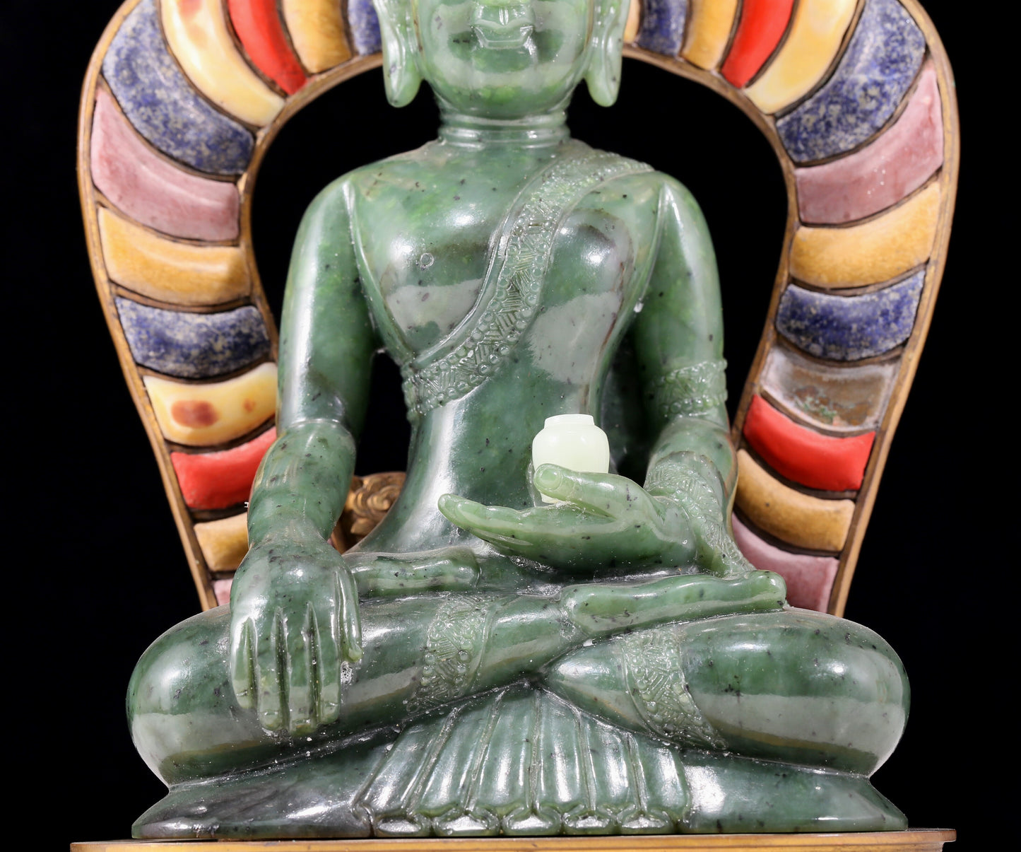 A solemn gilt bronze and gem-set jasper statue of Gautama Buddha