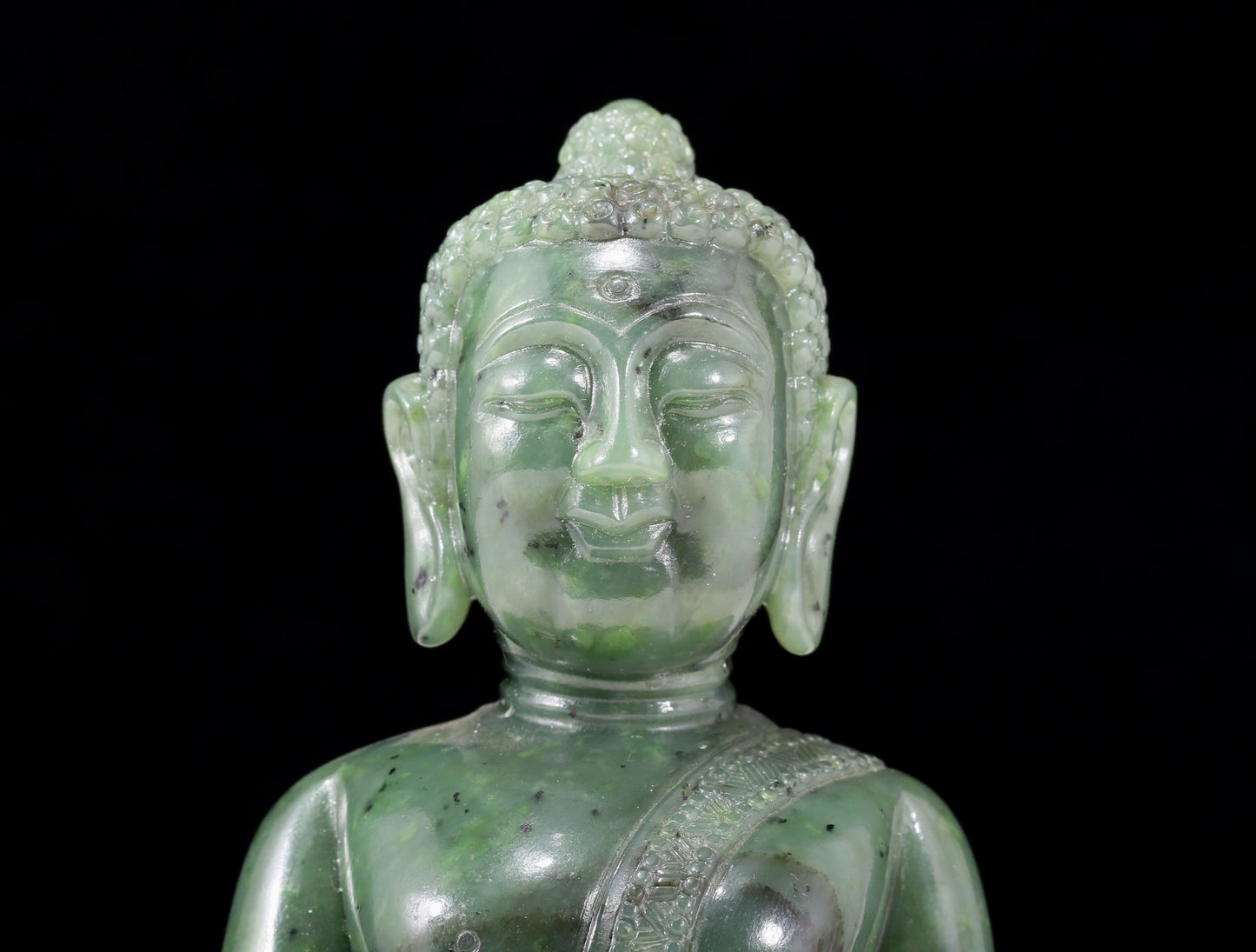 A solemn gilt bronze and gem-set jasper statue of Gautama Buddha