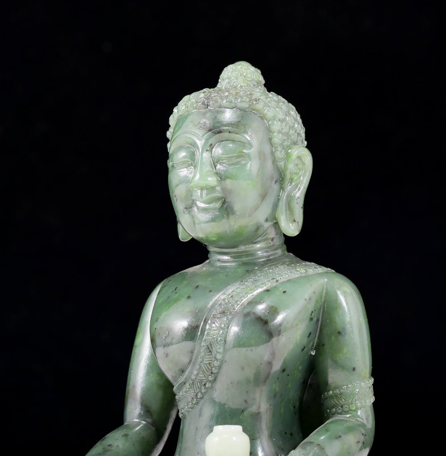 A solemn gilt bronze and gem-set jasper statue of Gautama Buddha