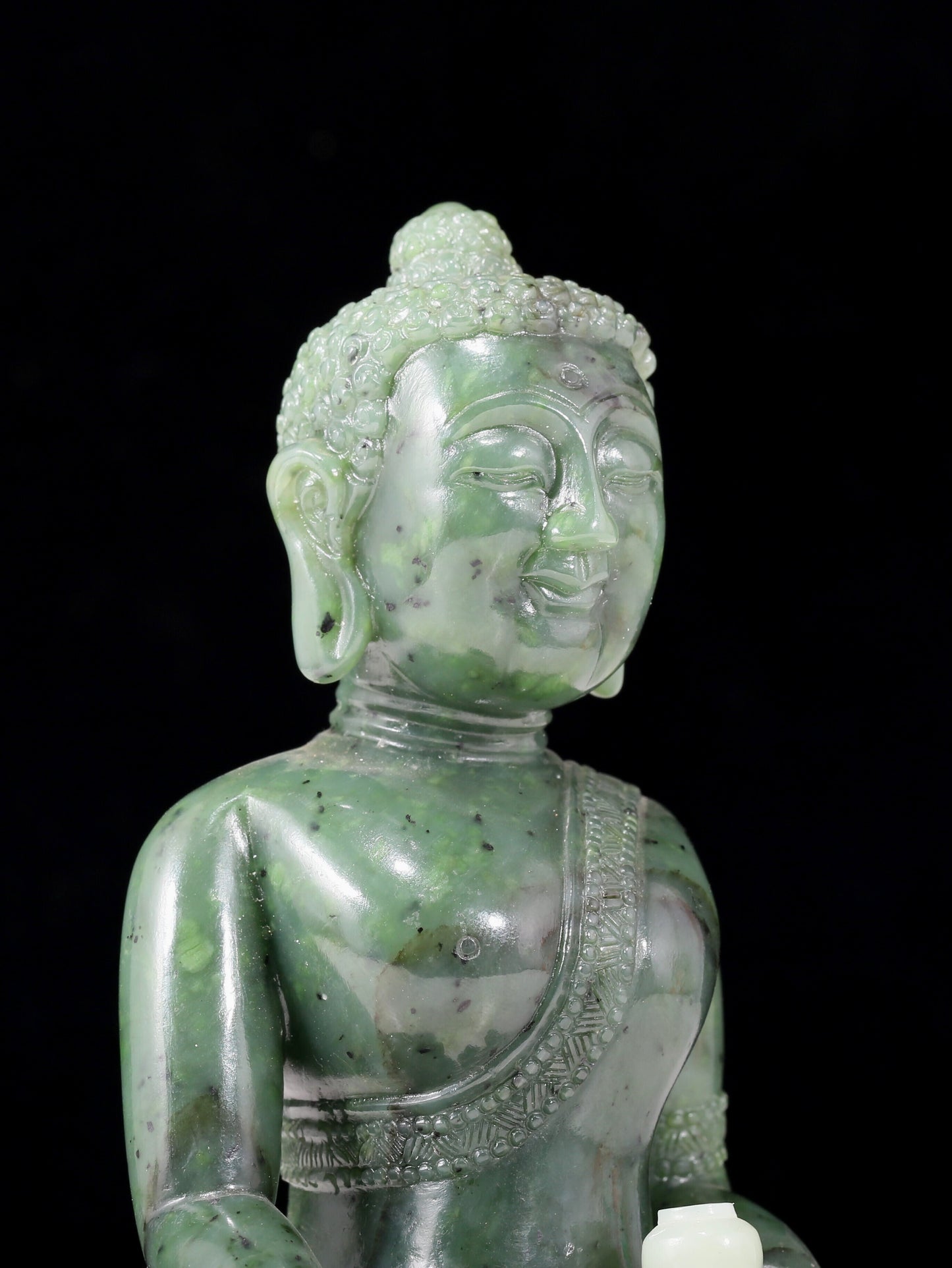 A solemn gilt bronze and gem-set jasper statue of Gautama Buddha