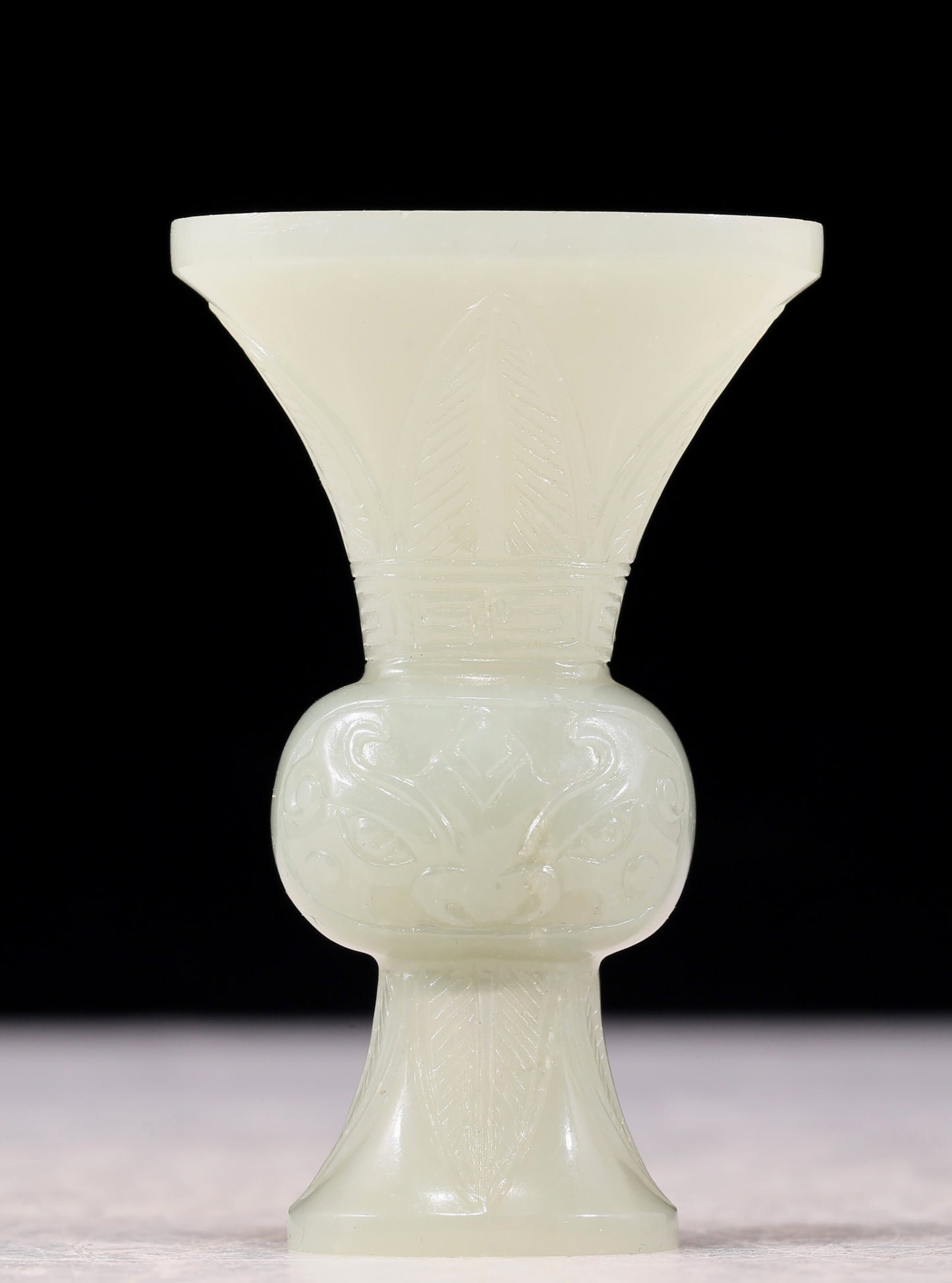 An exquisite white jade bottle with animal mask pattern