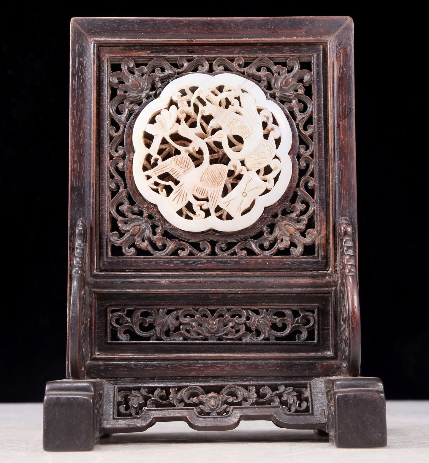 An exquisite zitanwood inlaid with white jade hollow carved flower and bird pattern table screen