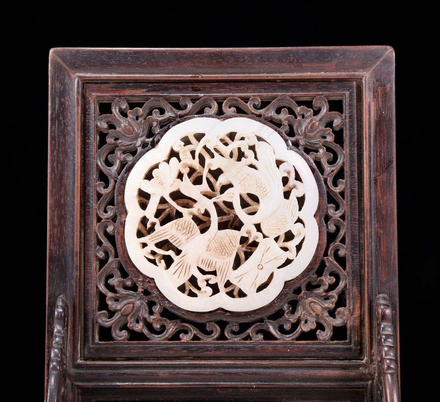 An exquisite zitanwood inlaid with white jade hollow carved flower and bird pattern table screen