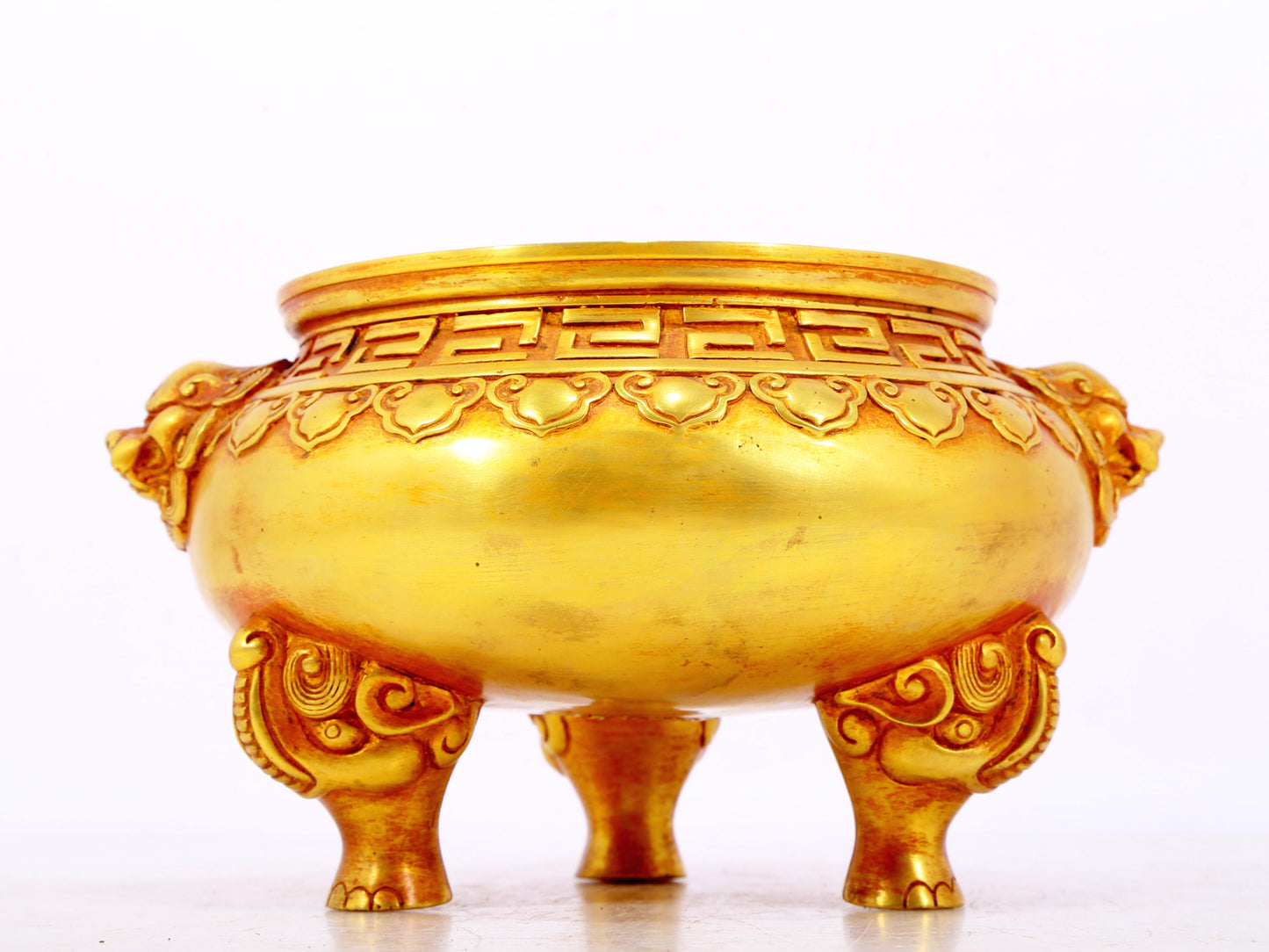 An exquisite gilt bronze lion-eared tripod censer