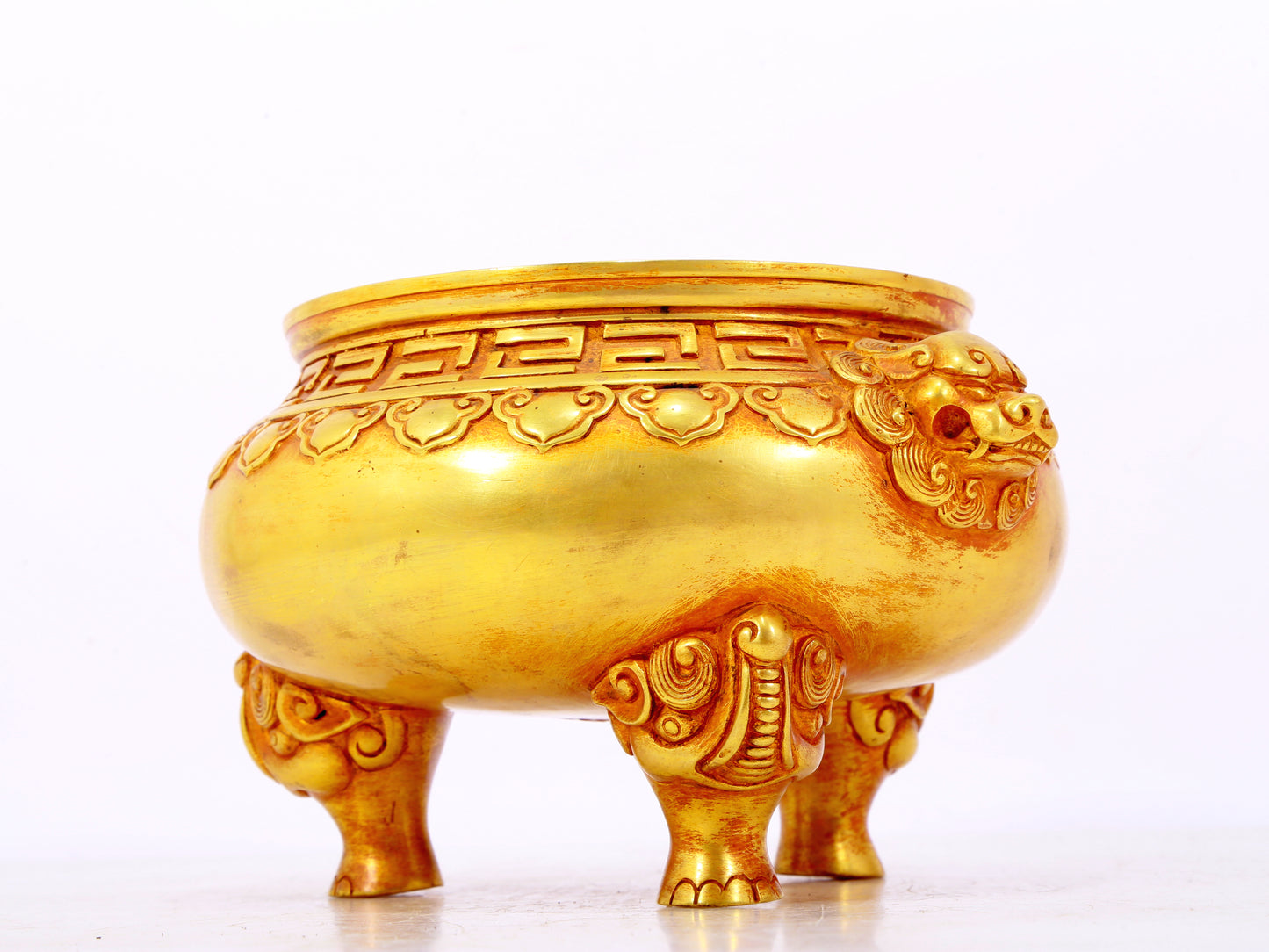 An exquisite gilt bronze lion-eared tripod censer