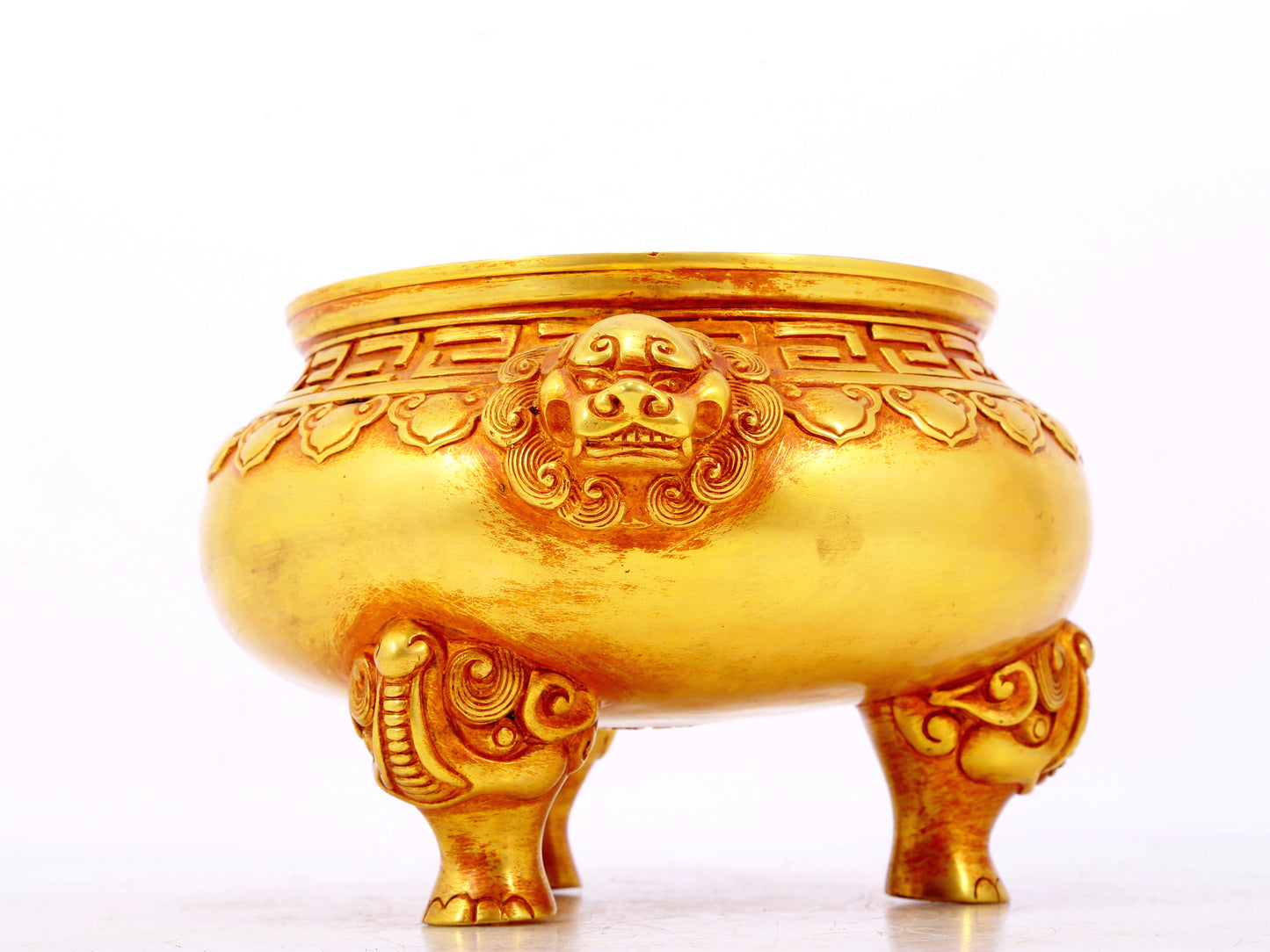 An exquisite gilt bronze lion-eared tripod censer