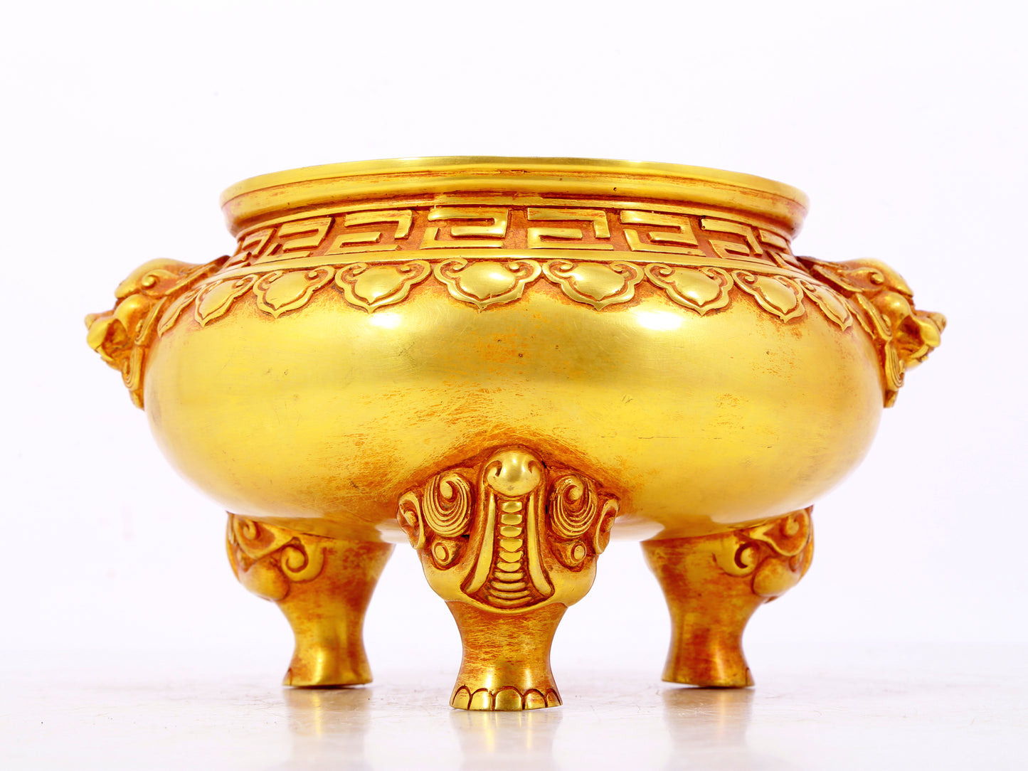 An exquisite gilt bronze lion-eared tripod censer