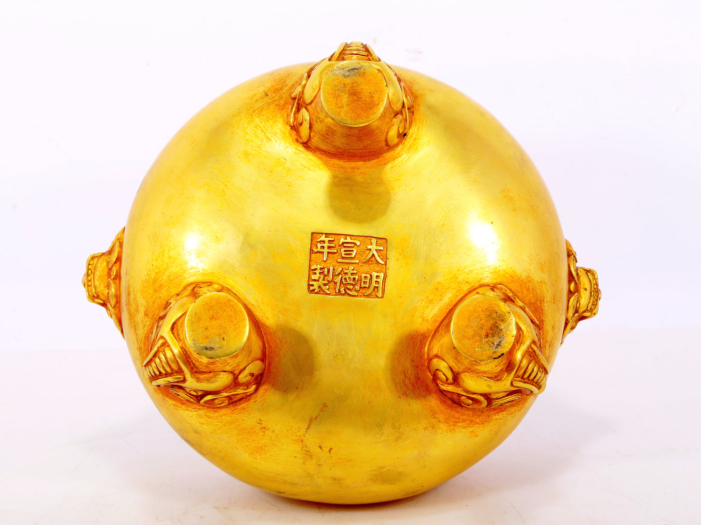 An exquisite gilt bronze lion-eared tripod censer