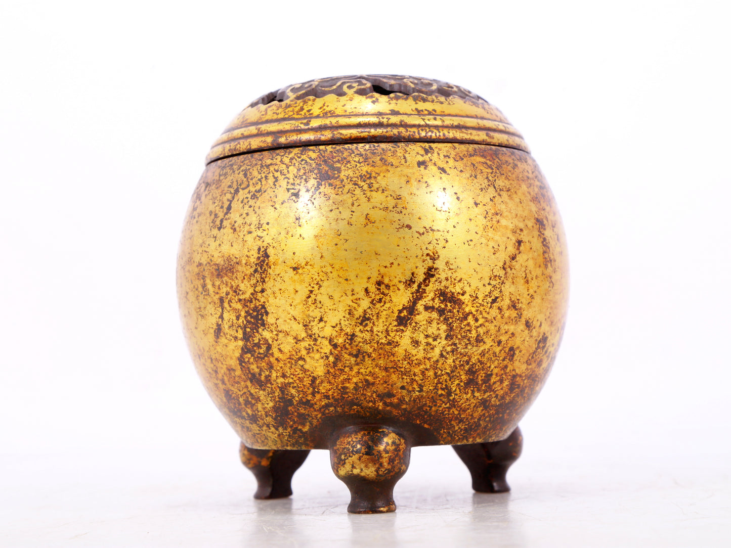 An exquisite gilt bronze tripod censer with lid