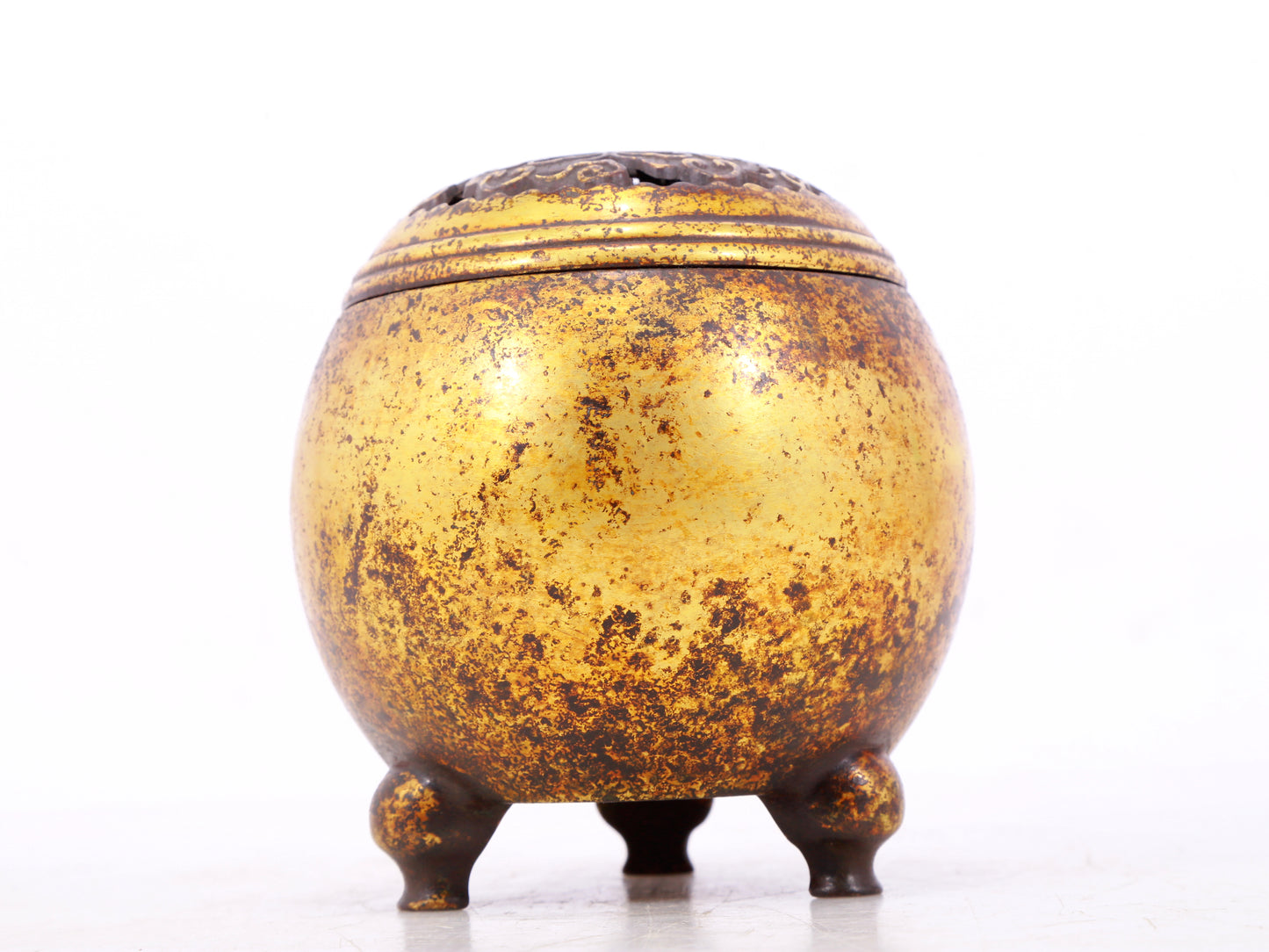 An exquisite gilt bronze tripod censer with lid