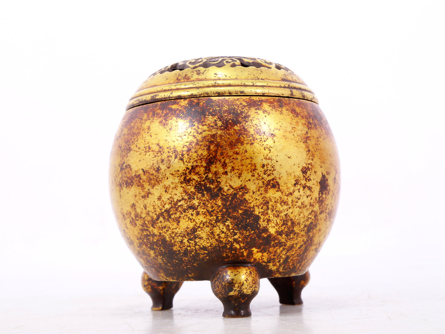 An exquisite gilt bronze tripod censer with lid