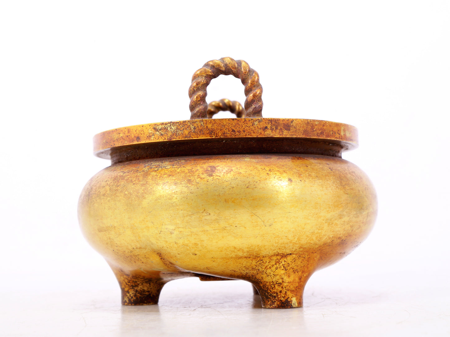 An exquisite gilt bronze censer with double ears and three legs