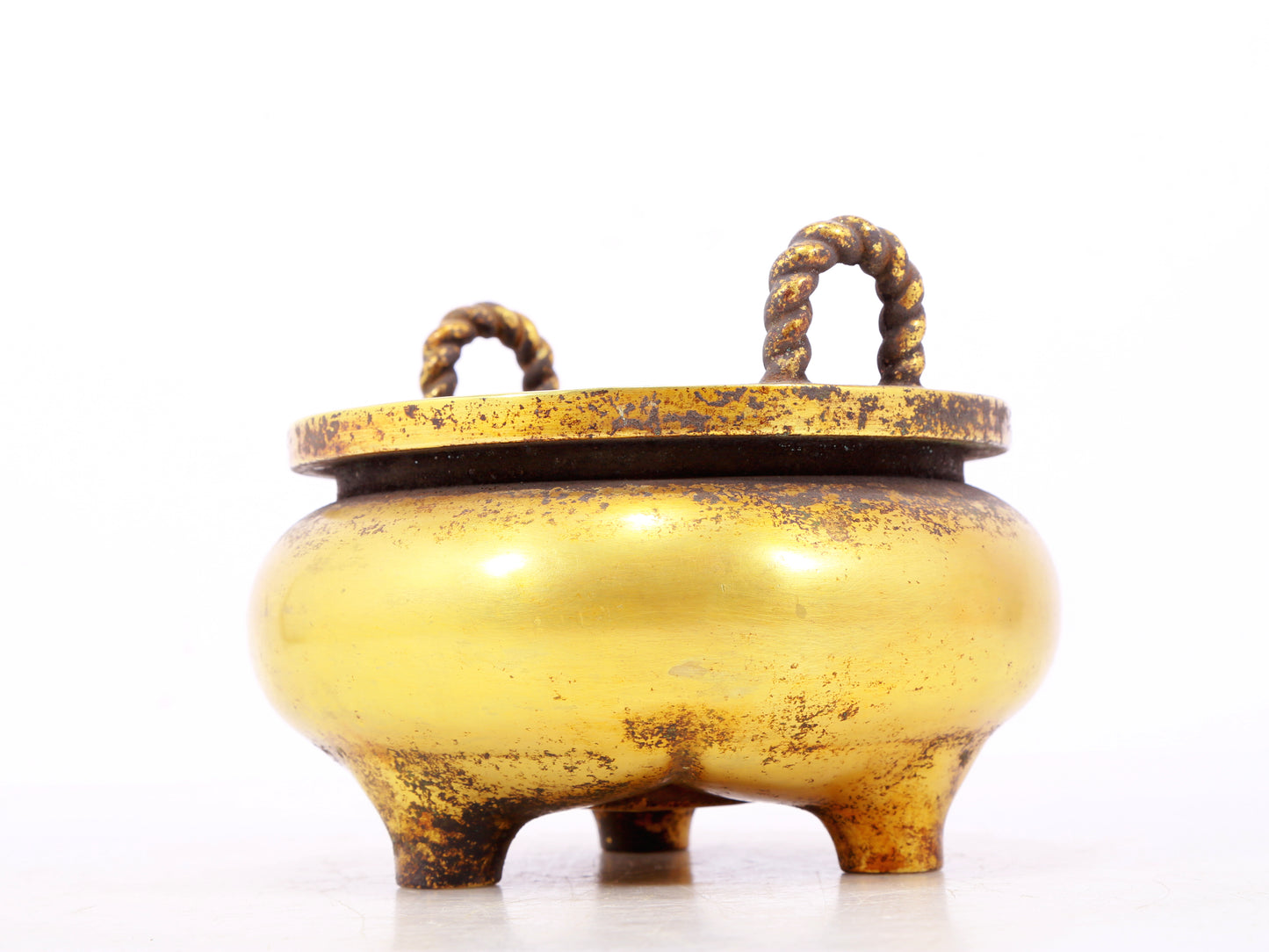 An exquisite gilt bronze censer with double ears and three legs