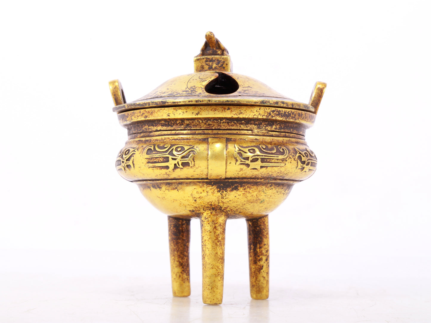 An exquisite gilt bronze censer with double ears and three legs with auspicious animal patterns and a lid