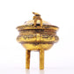 An exquisite gilt bronze censer with double ears and three legs with auspicious animal patterns and a lid