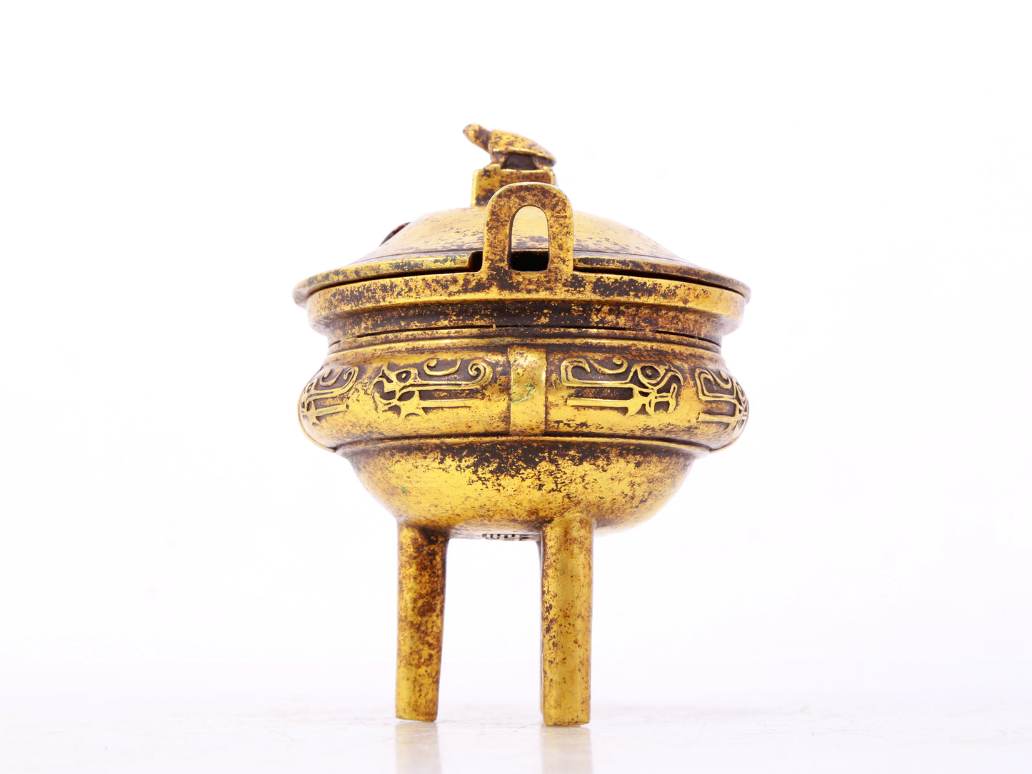 An exquisite gilt bronze censer with double ears and three legs with auspicious animal patterns and a lid