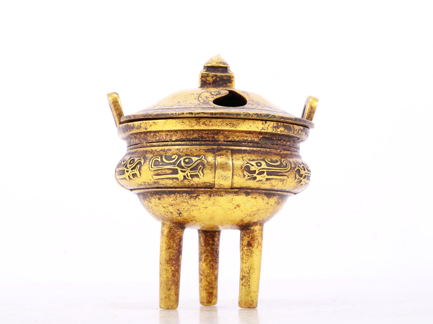 An exquisite gilt bronze censer with double ears and three legs with auspicious animal patterns and a lid