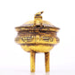 An exquisite gilt bronze censer with double ears and three legs with auspicious animal patterns and a lid