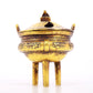 An exquisite gilt bronze censer with double ears and three legs with auspicious animal patterns and a lid