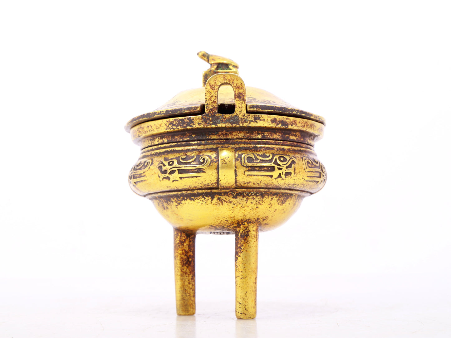 An exquisite gilt bronze censer with double ears and three legs with auspicious animal patterns and a lid