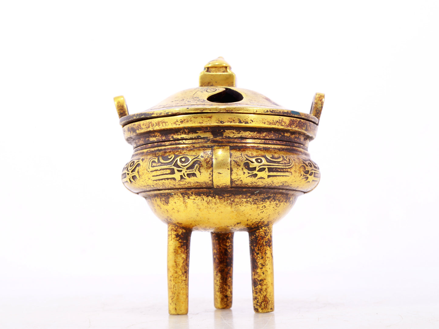 An exquisite gilt bronze censer with double ears and three legs with auspicious animal patterns and a lid