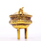 An exquisite gilt bronze censer with double ears and three legs with auspicious animal patterns and a lid