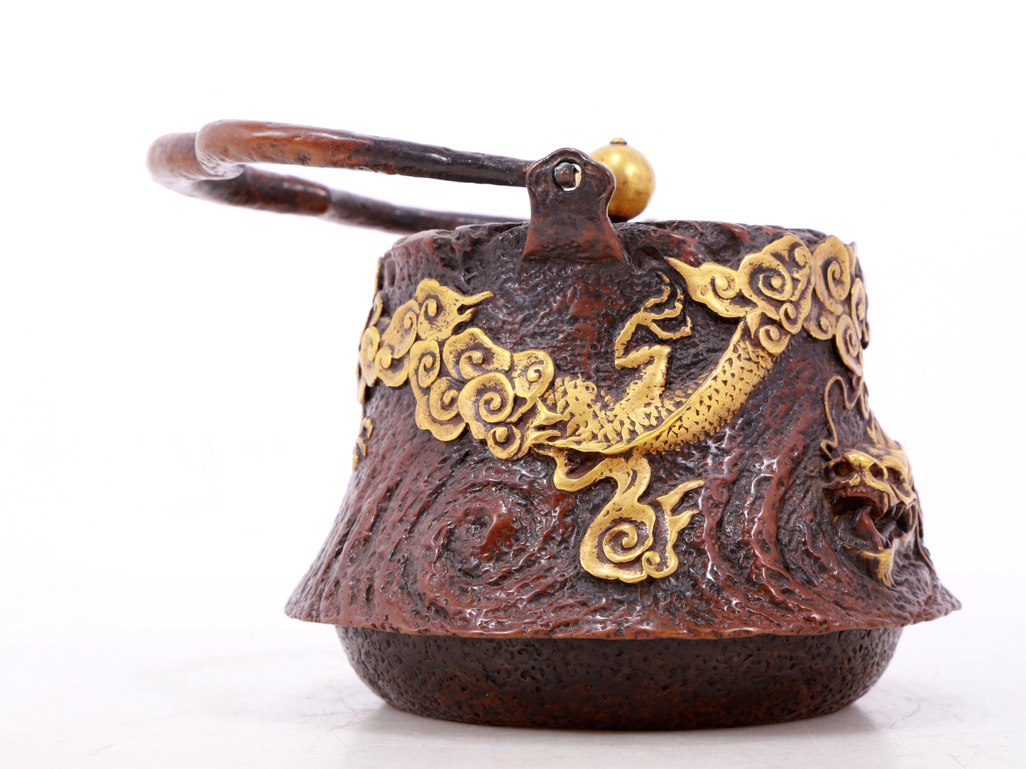 An exquisite gilt bronze teapot with auspicious clouds and dragon pattern