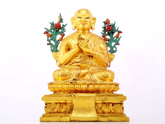 A solemn gilt bronze statue of the Guru