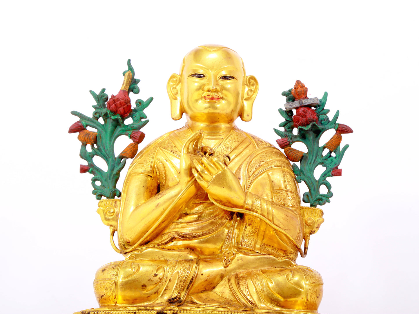 A solemn gilt bronze statue of the Guru